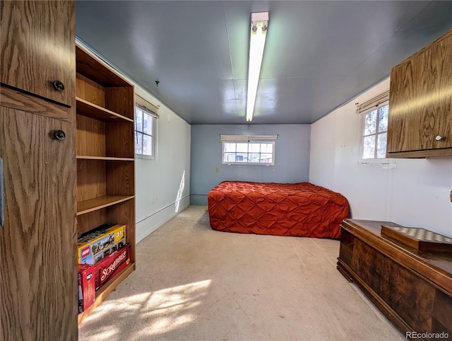 carpeted bedroom featuring multiple windows