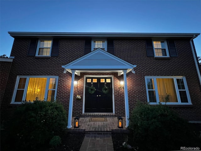 traditional-style home with brick siding