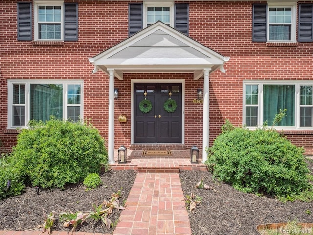 property entrance with brick siding