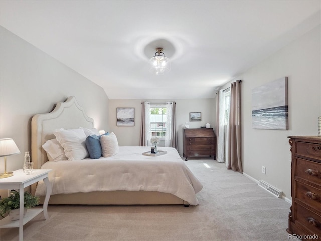 bedroom with light carpet and baseboards