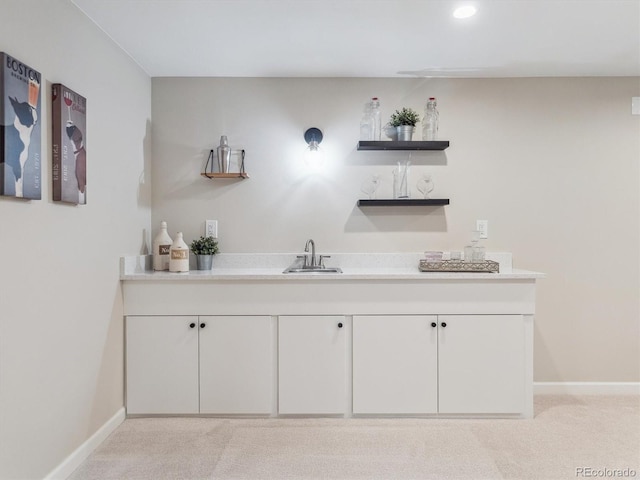 indoor wet bar featuring light carpet, baseboards, and recessed lighting