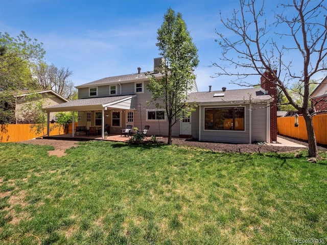 rear view of property featuring a patio and a chimney
