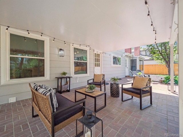 view of patio / terrace featuring outdoor lounge area and fence