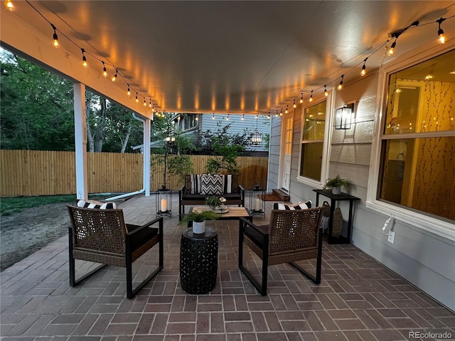 view of patio with an outdoor hangout area and fence