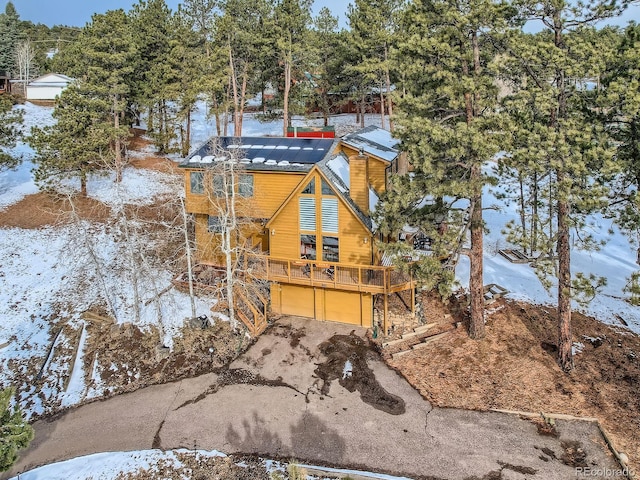 view of snowy exterior featuring a garage