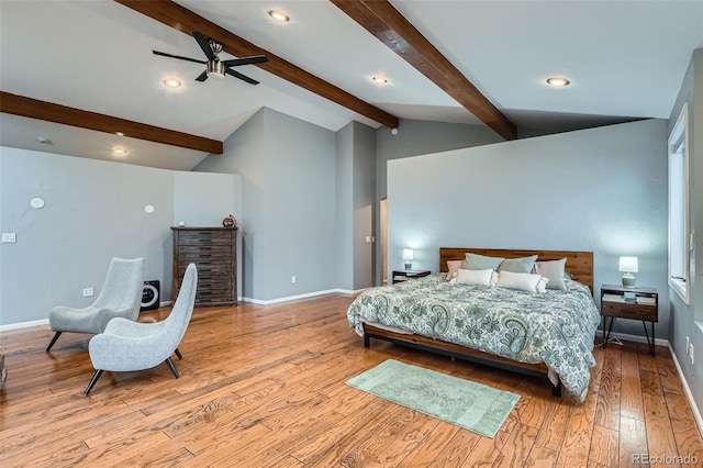 bedroom featuring ceiling fan, light hardwood / wood-style floors, and vaulted ceiling with beams