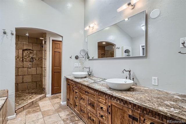 bathroom featuring vanity and tiled shower