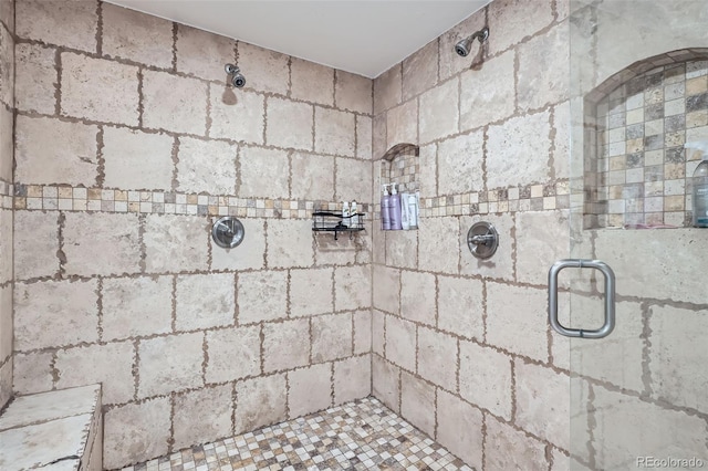 bathroom with a shower with door