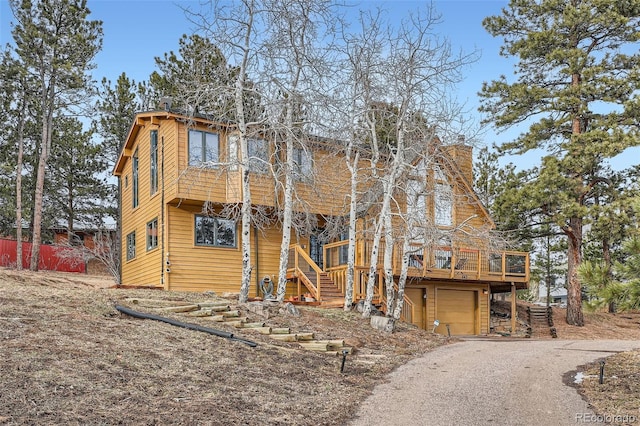 view of front of home with a garage and a wooden deck