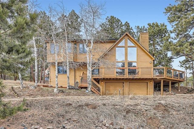 cabin featuring a garage and a deck