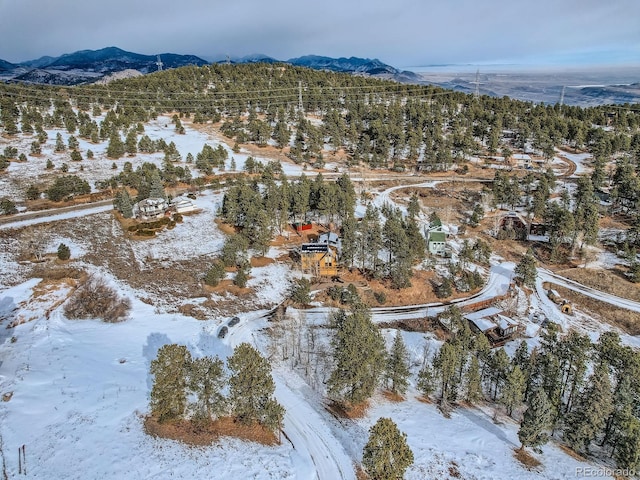 snowy aerial view featuring a mountain view