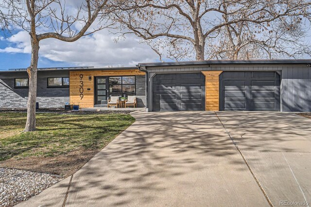 9309 Highland Pl, Arvada, CO 80002 - view of front of house with an attached garage and driveway