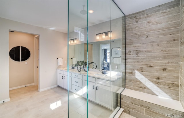 8576 Hotchkiss St, Littleton, CO 80125 - full bath with double vanity, a sink, and a shower stall