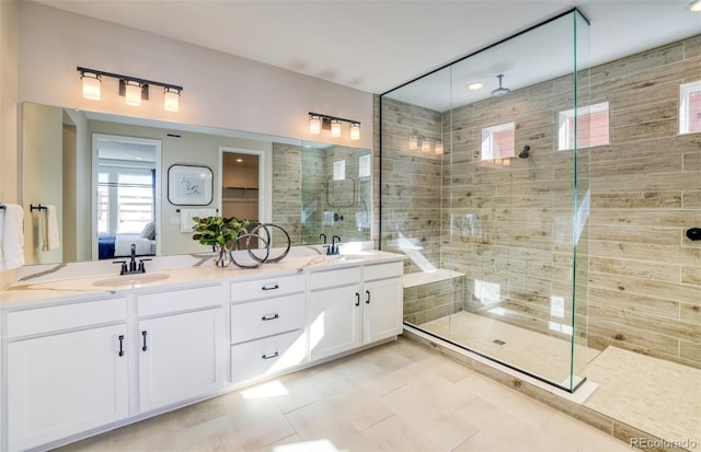 8576 Hotchkiss St, Littleton, CO 80125 - ensuite bathroom featuring double vanity, a sink, and a shower stall