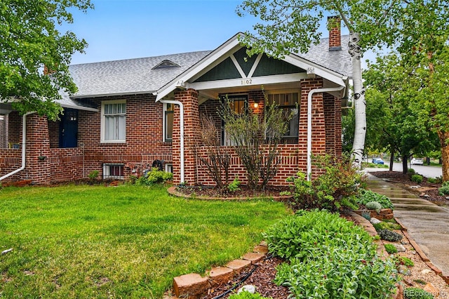 1602 Garfield St, Denver, CO 80206 - view of front of property featuring a chimney, a front yard, brick siding, roof with shingles, and a porch