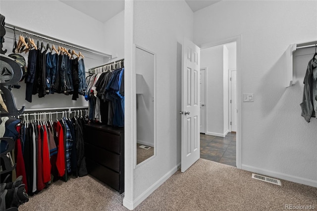 walk in closet featuring carpet floors