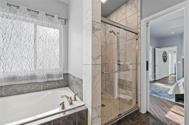 bathroom with tile patterned flooring and shower with separate bathtub