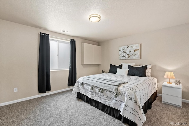 bedroom featuring carpet flooring, a textured ceiling, and baseboards