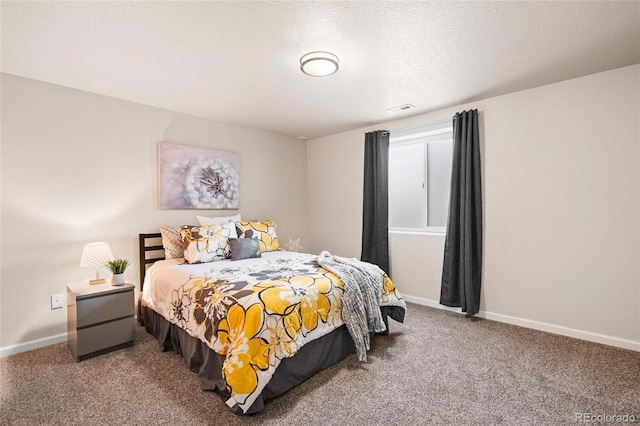 bedroom featuring a textured ceiling, carpet, visible vents, and baseboards