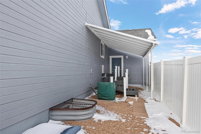 view of snow covered exterior featuring fence