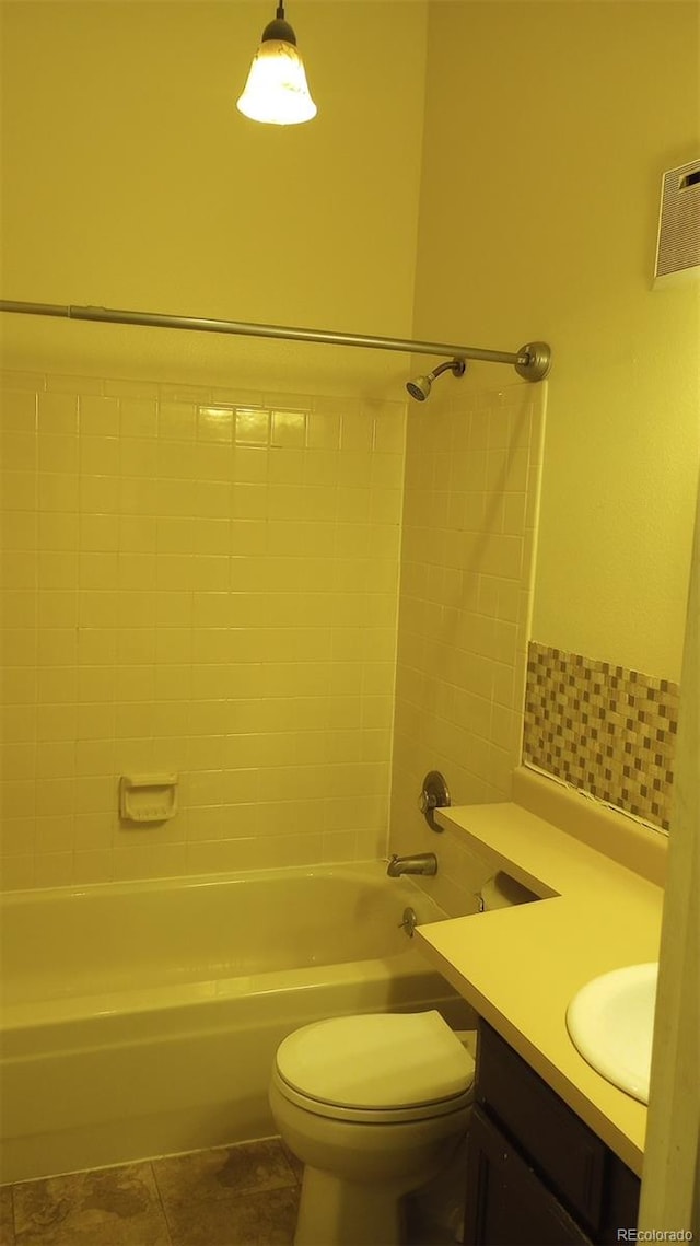 full bathroom featuring vanity, tiled shower / bath combo, toilet, and tile patterned floors