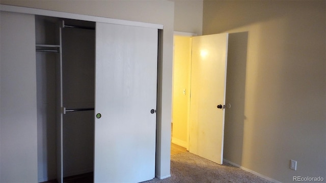 unfurnished bedroom featuring a closet and carpet flooring