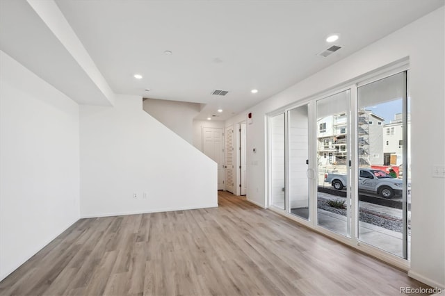 unfurnished room with light wood-type flooring