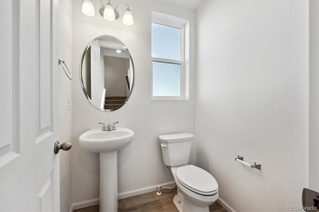 bathroom with sink, hardwood / wood-style floors, and toilet