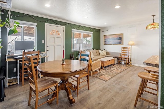 dining space with recessed lighting, crown molding, baseboards, and wood finished floors