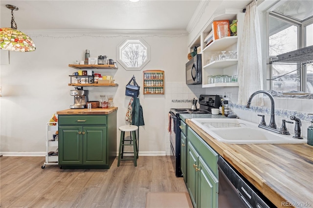 kitchen with a sink, open shelves, black appliances, and green cabinetry