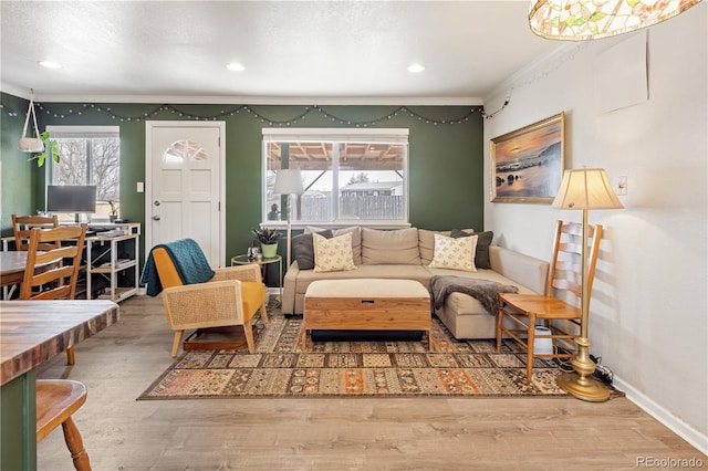 living room featuring crown molding, recessed lighting, wood finished floors, and baseboards