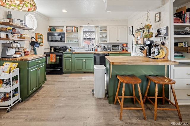 kitchen featuring wooden counters, black appliances, open shelves, and green cabinetry