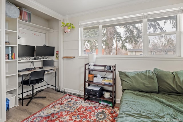 bedroom featuring ornamental molding and wood finished floors