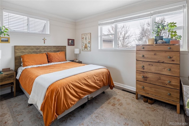 bedroom with crown molding, visible vents, and baseboards