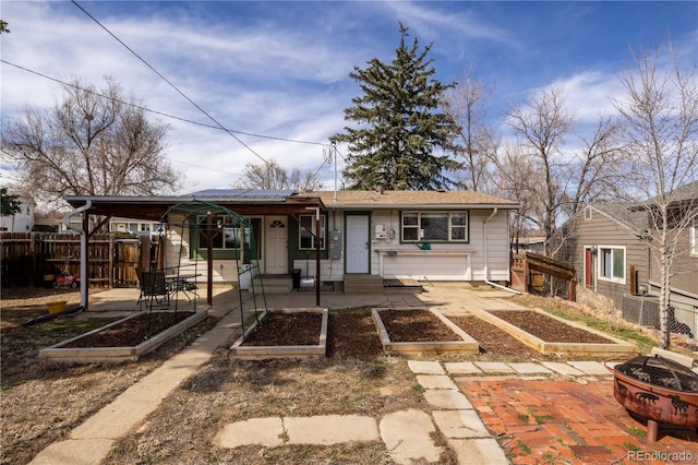 rear view of house with central AC unit, a garden, a patio area, and fence