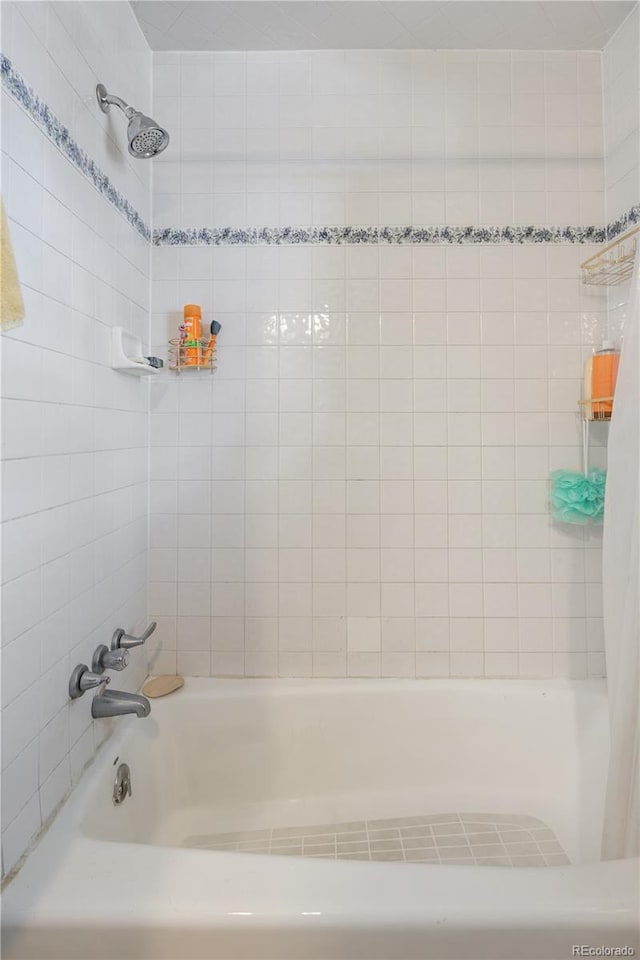 bathroom with shower / bathtub combination with curtain