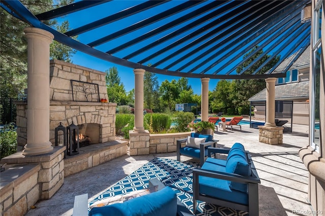 view of patio / terrace featuring a pergola and an outdoor stone fireplace