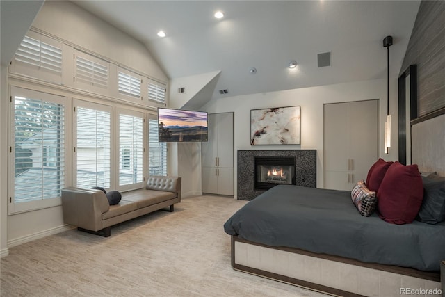 carpeted bedroom with high vaulted ceiling