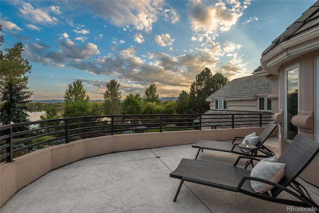 patio terrace at dusk with a balcony