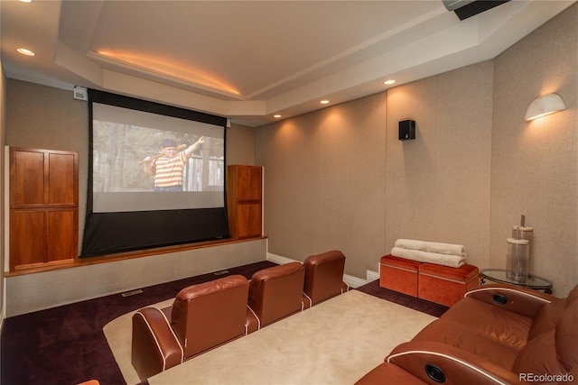 cinema room with a tray ceiling and carpet floors