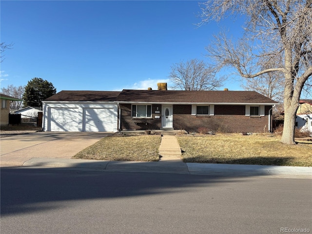 single story home with a garage, concrete driveway, and brick siding