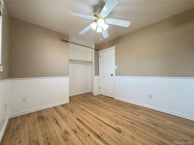 unfurnished bedroom with a ceiling fan, a closet, baseboards, and wood finished floors