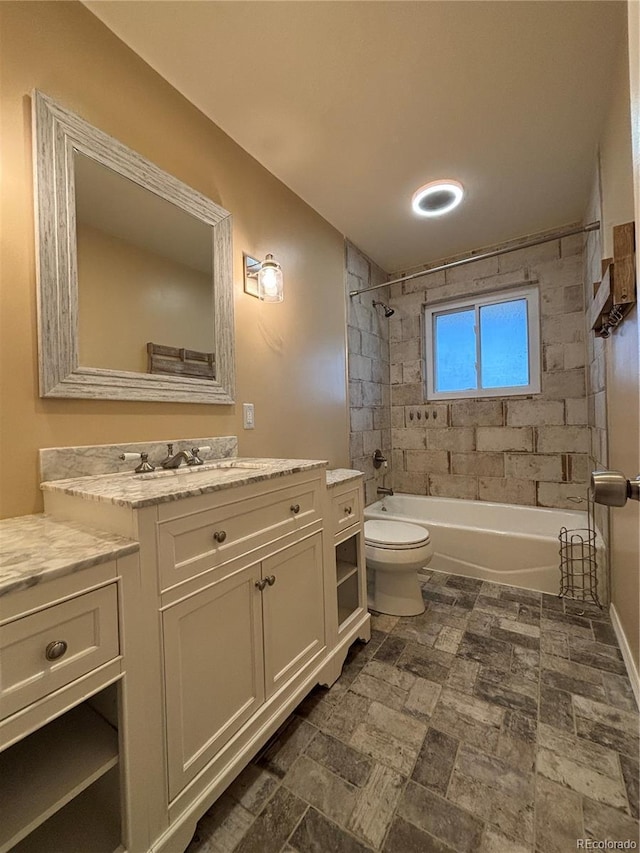 bathroom with shower / washtub combination, vanity, and toilet