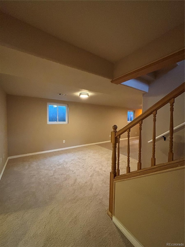 basement with carpet flooring, stairway, and baseboards