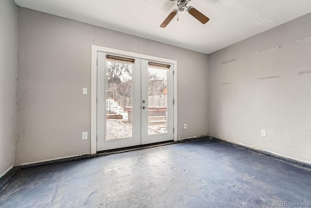 spare room with concrete flooring, french doors, and ceiling fan