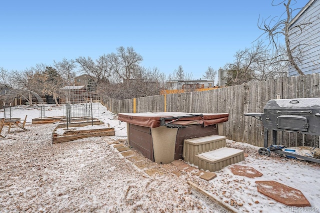 view of yard featuring a hot tub and a fenced backyard