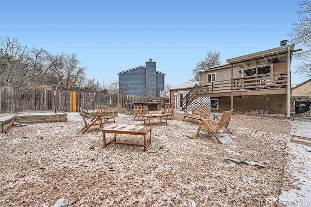 view of yard with an outdoor fire pit, fence, stairs, a wooden deck, and a patio area