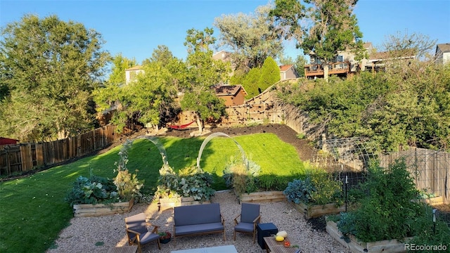 view of yard featuring a garden and a fenced backyard