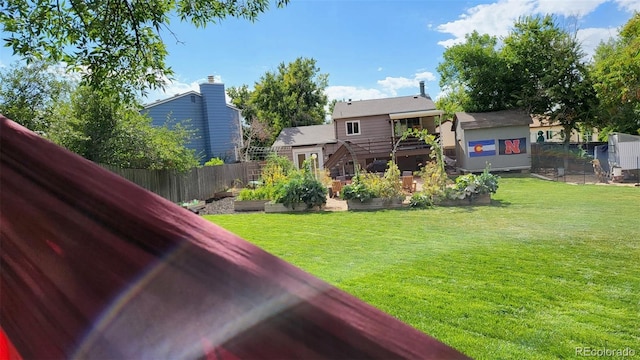 view of yard featuring fence and a garden