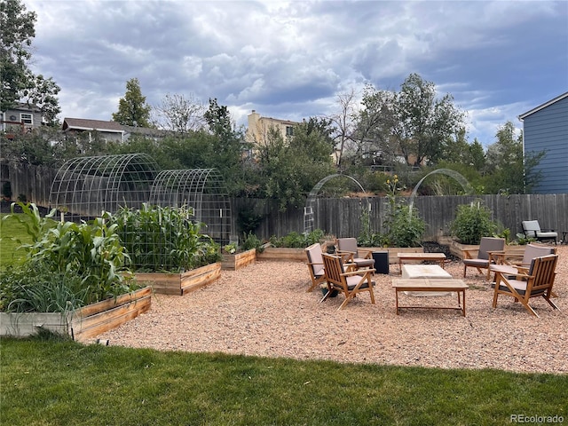 view of yard with a vegetable garden and fence